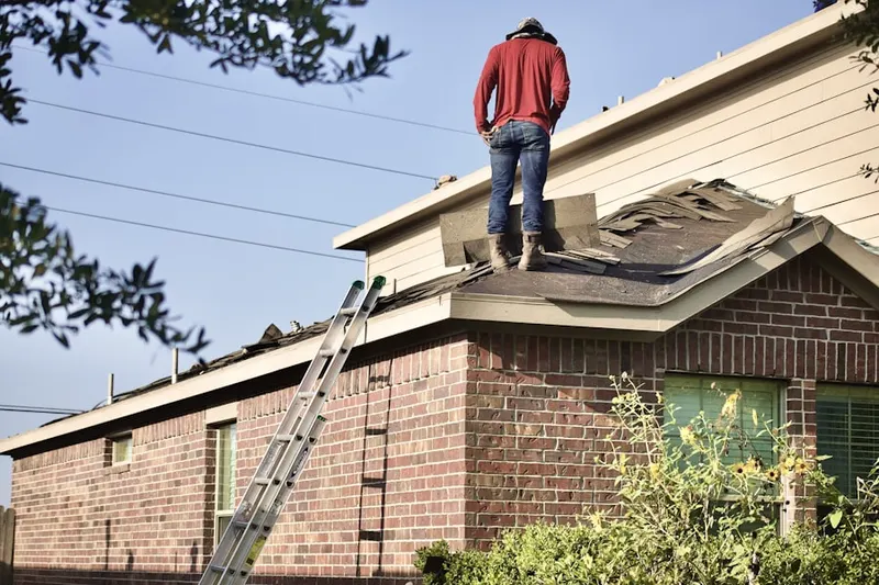 Professional roofer working on a residential roof in Solsville